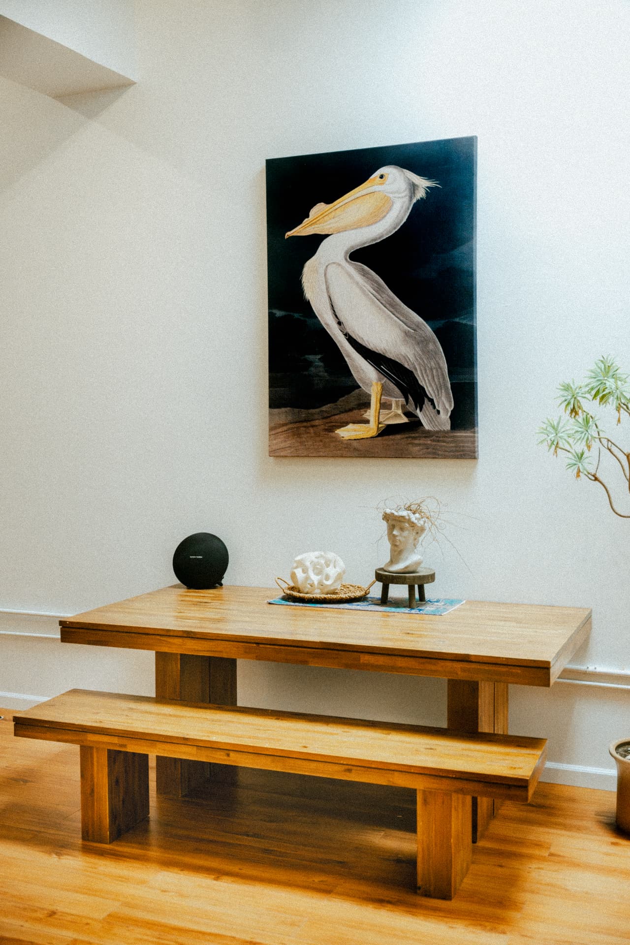 Long wood table beneath a pelican painting at Recovery Republic men's treatment center