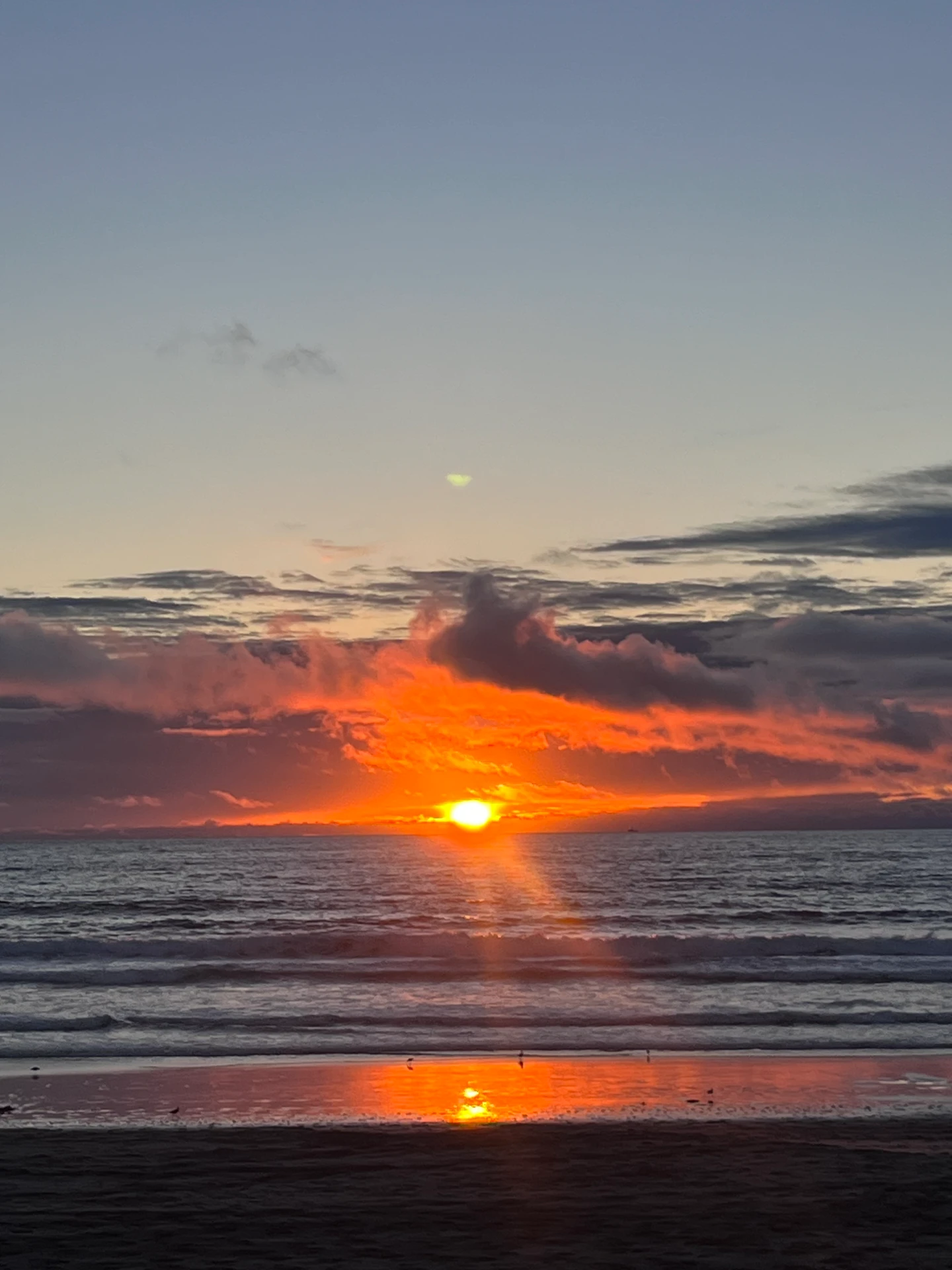 Sun dropping into the ocean over the beach during a Recovery Republic adventure therapy trip in Baja
