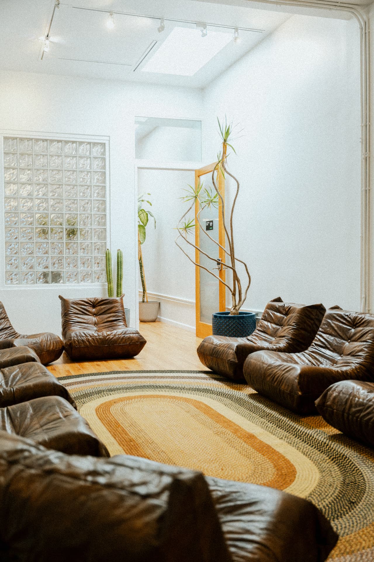 Group therapy room looking toward the glass-block window at Recovery Republic
