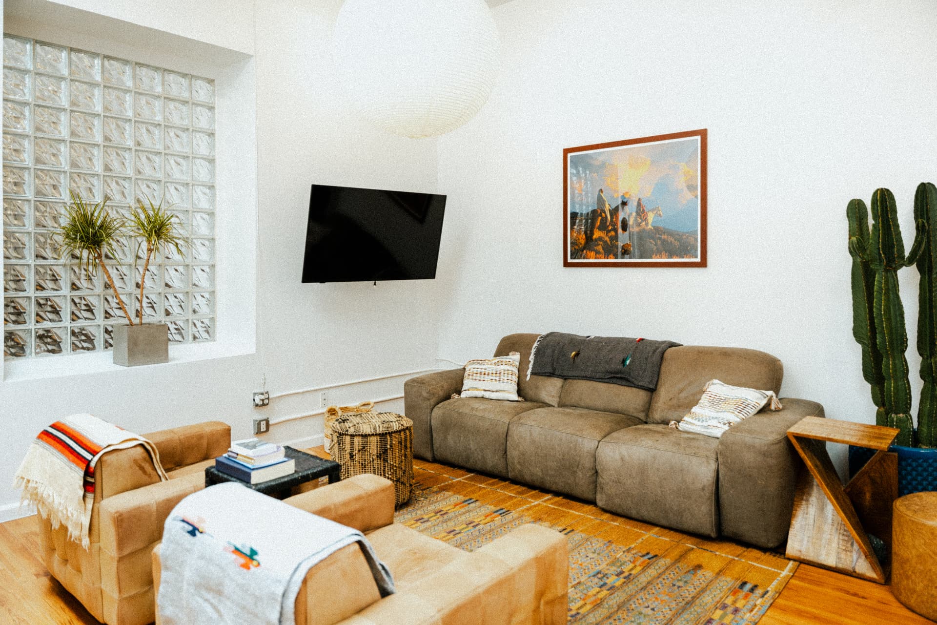 Lounge area with sofa and framed artwork at Recovery Republic men's treatment center
