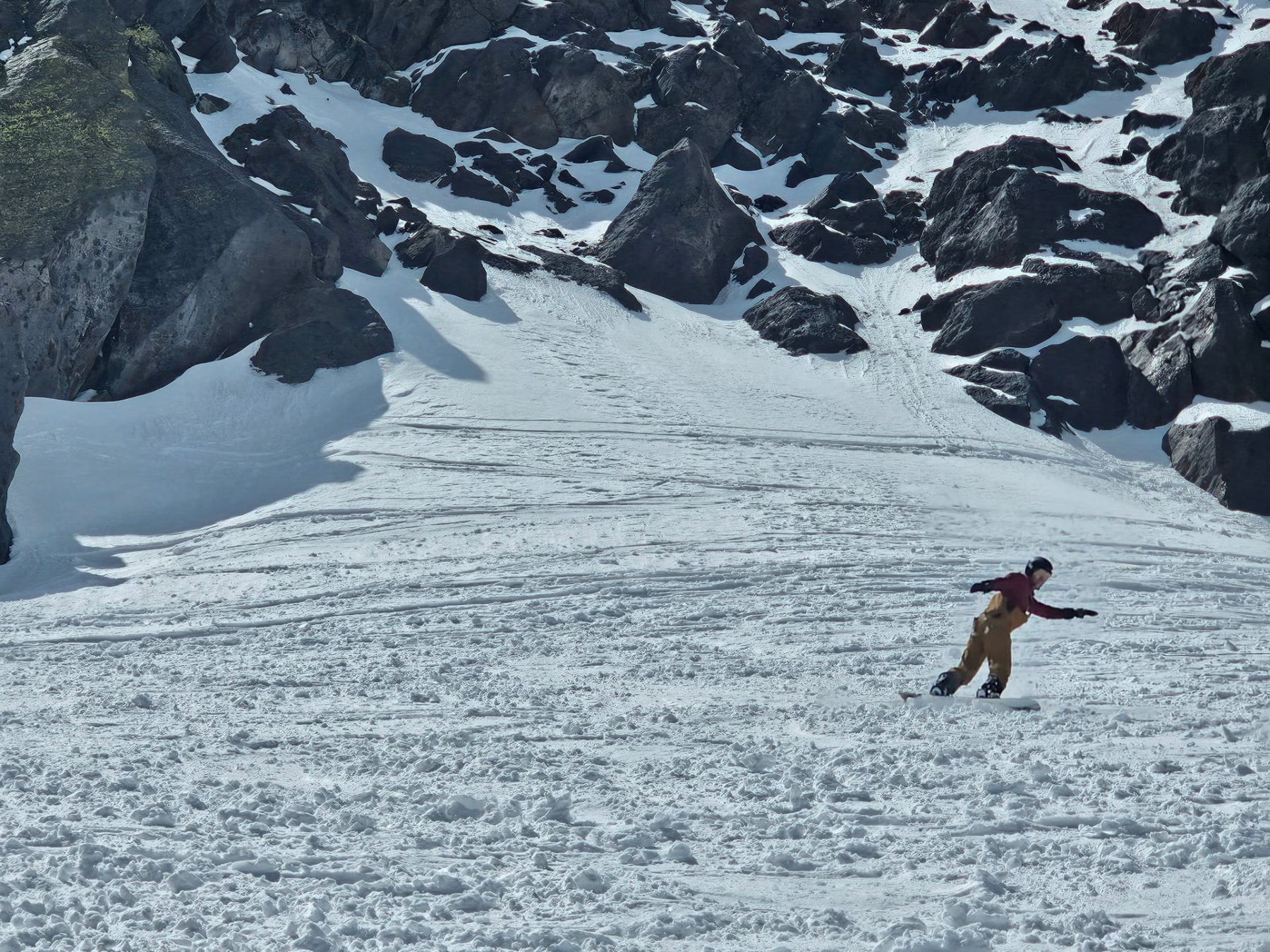 Snowboarding out of the rocks in the upper bowl at Mammoth during outdoor experiential therapy