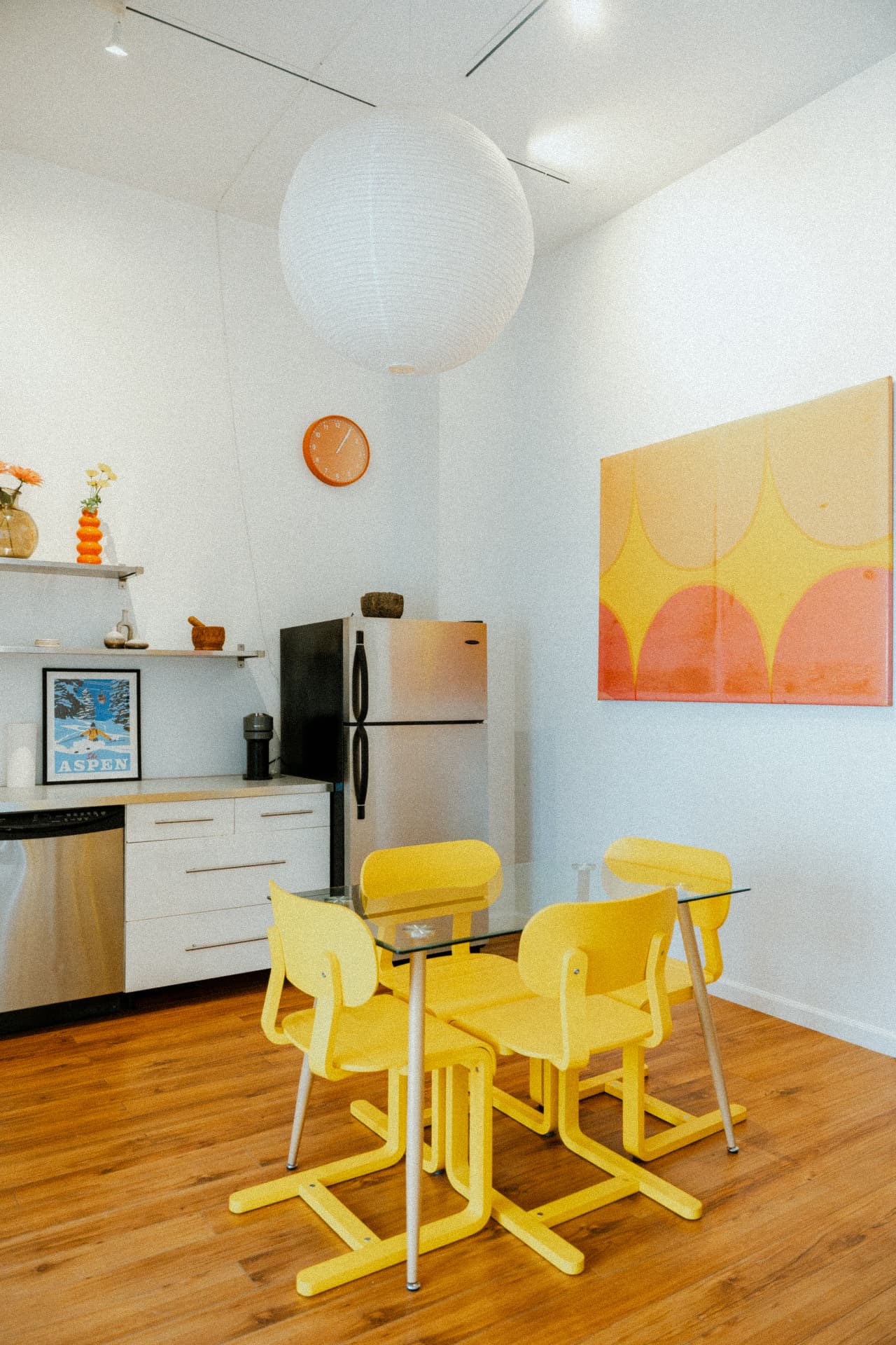 Kitchen with yellow chairs and citrus canvas at Recovery Republic men's treatment center