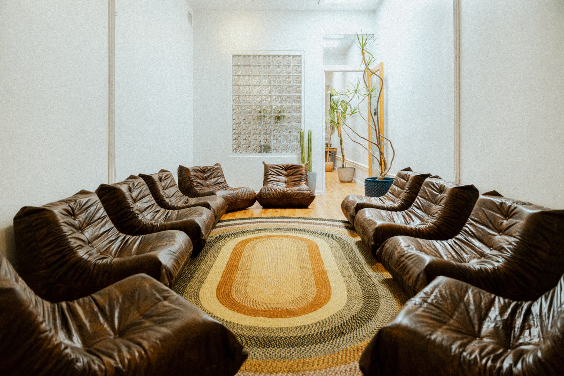Circle of vintage leather chairs in the men's group therapy room at Recovery Republic