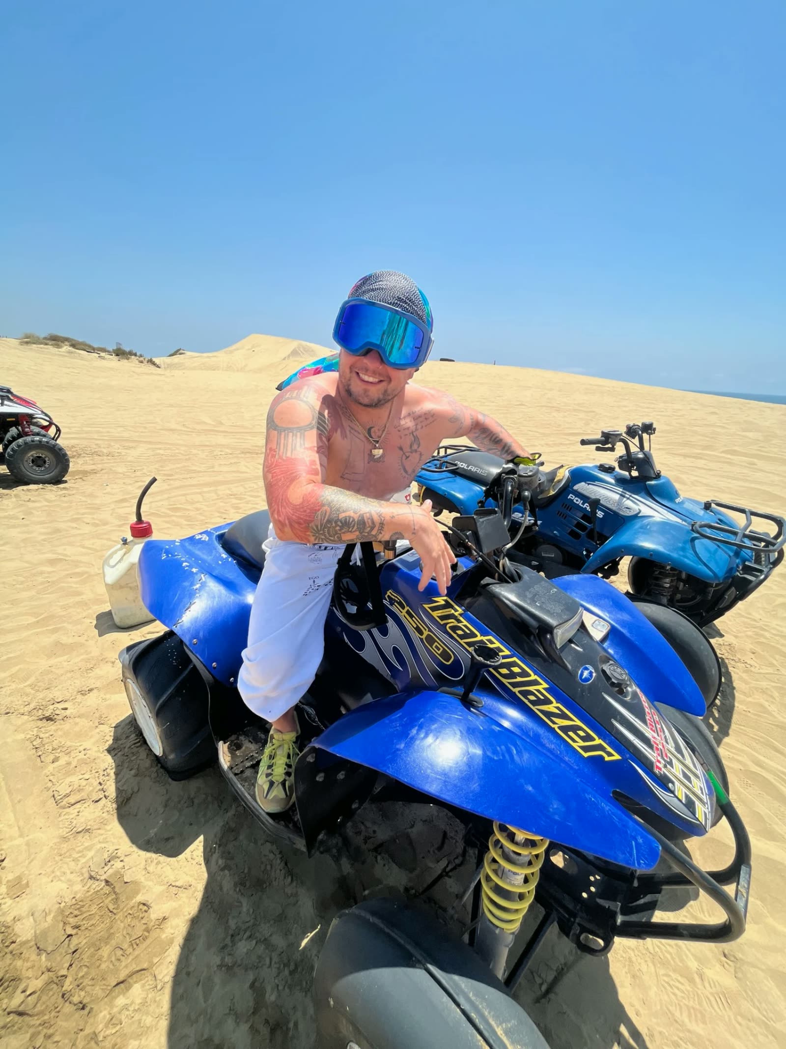 Man sitting a quad in the Baja dunes during outdoor experiential therapy