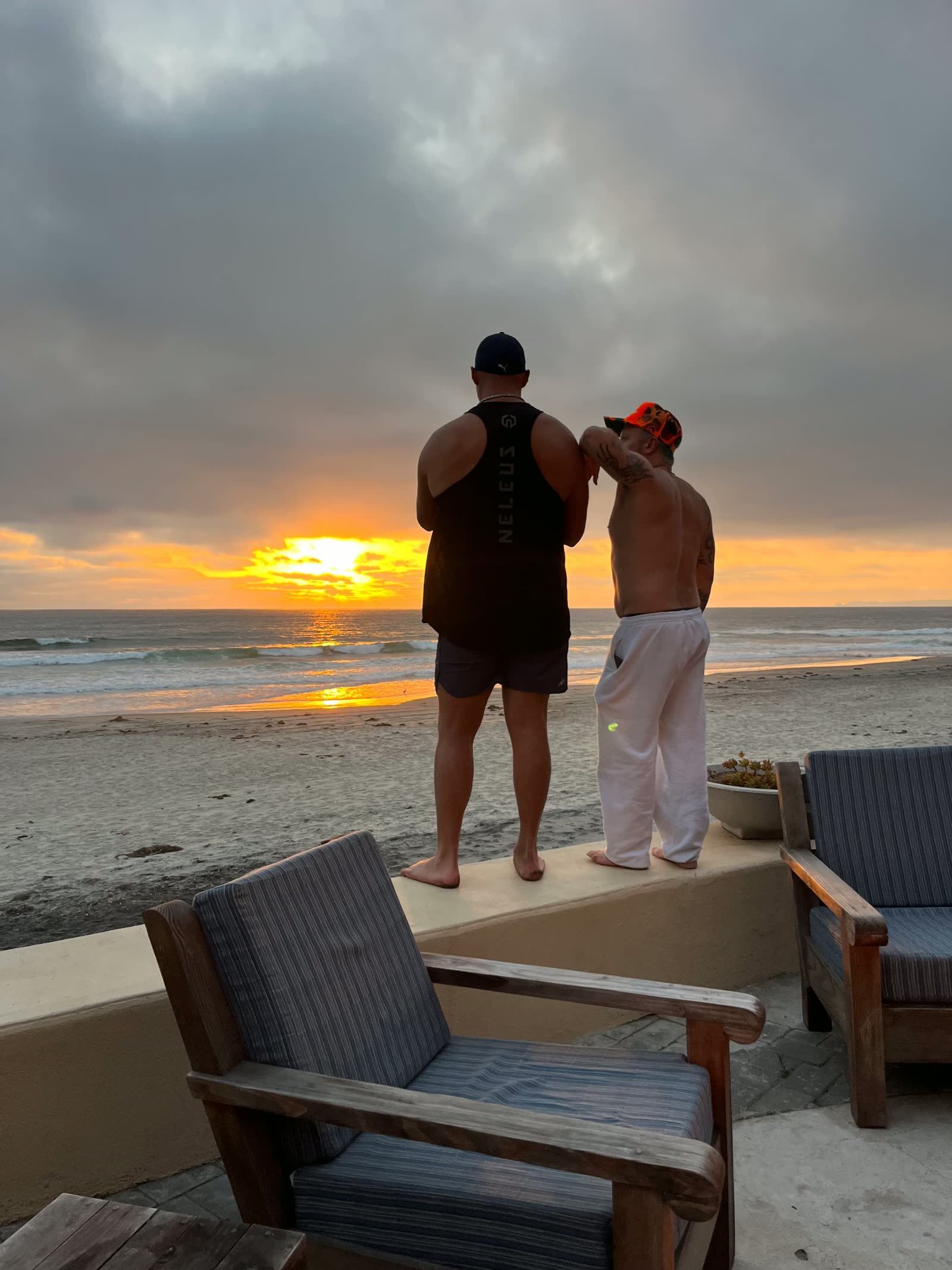 Two men watching the sun drop into the Pacific during a Recovery Republic adventure therapy trip