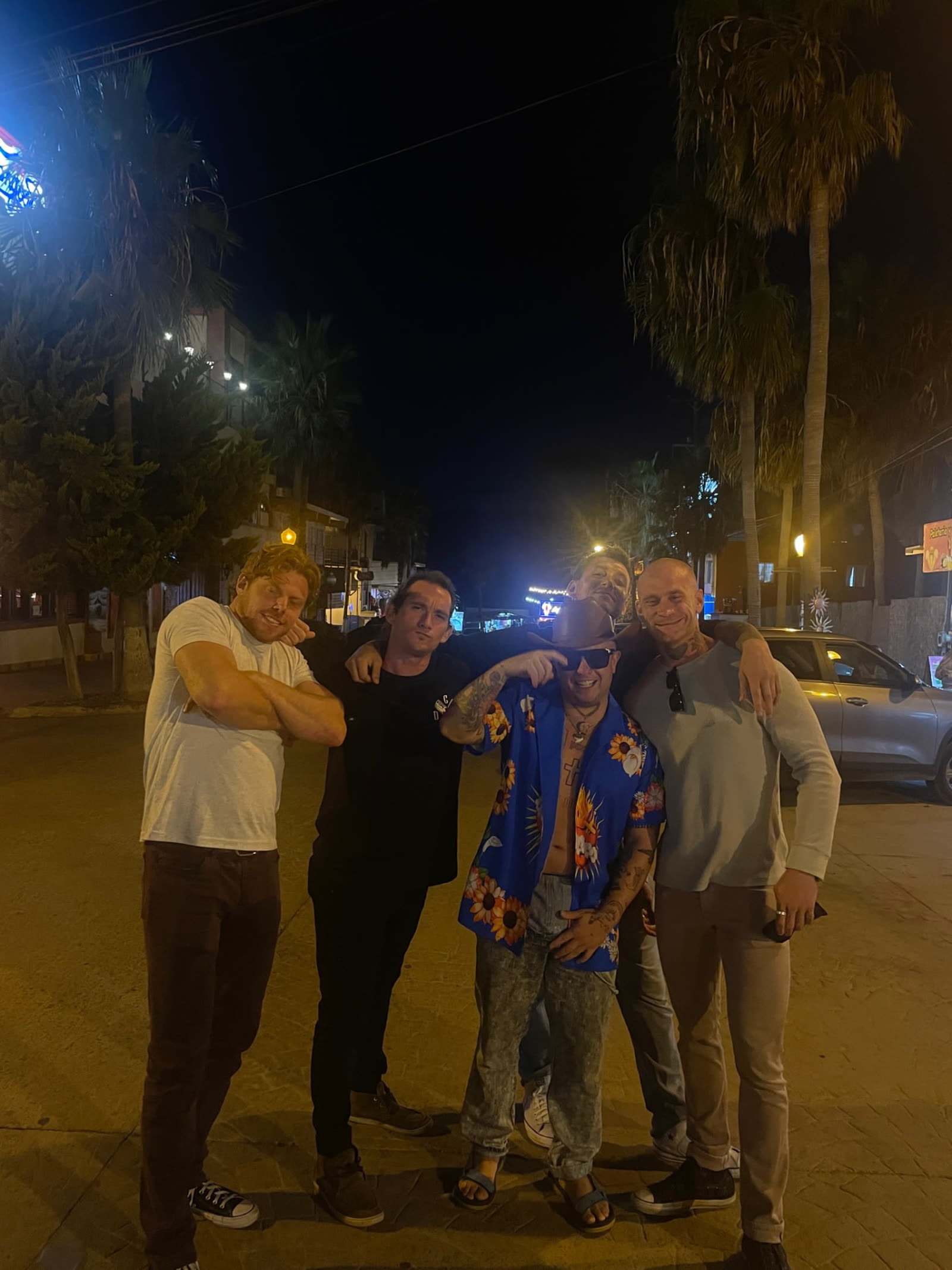 The crew on the street at night under the palms in Baja