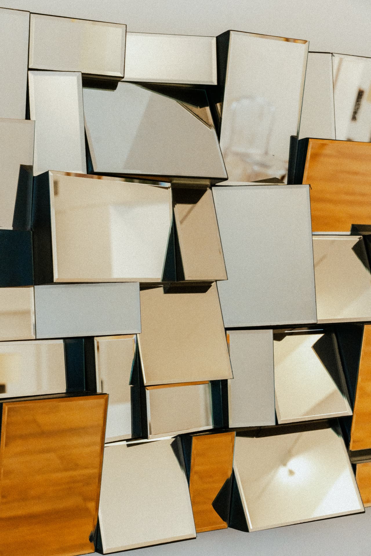 Faceted mirror wall sculpture catching afternoon light at Recovery Republic